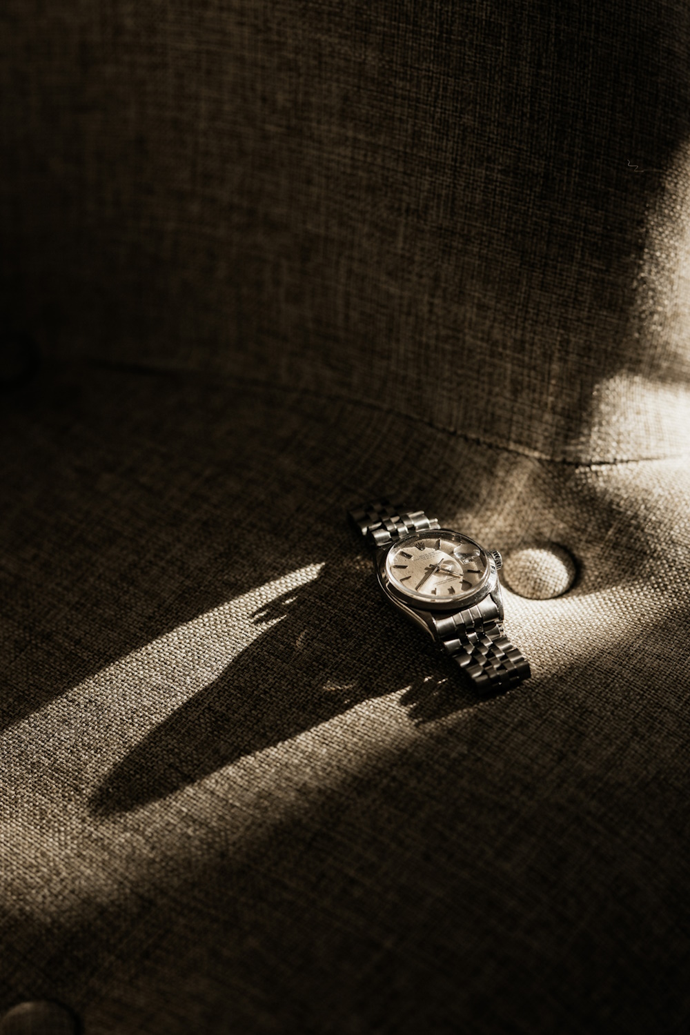 A vintage watch on a table catching the sunlight